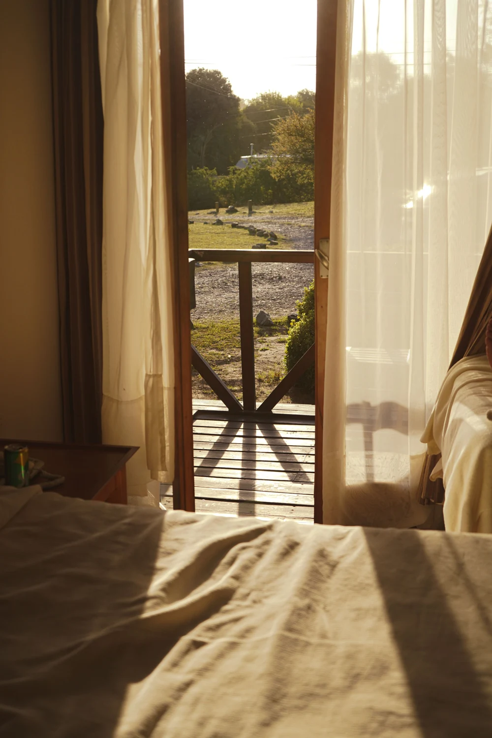 Linen in afternoon light, beside an open wooden door and a soft curtain